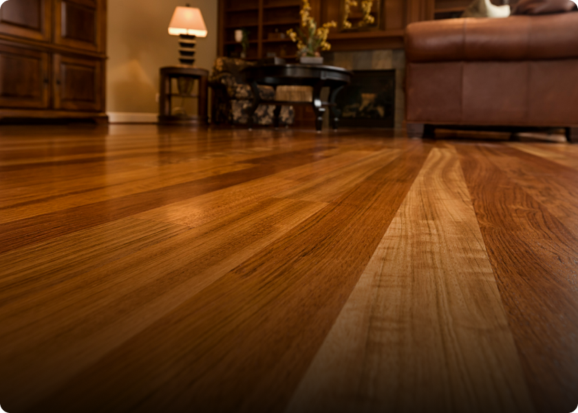 Close-up of polished wooden floor in a cozy living room.