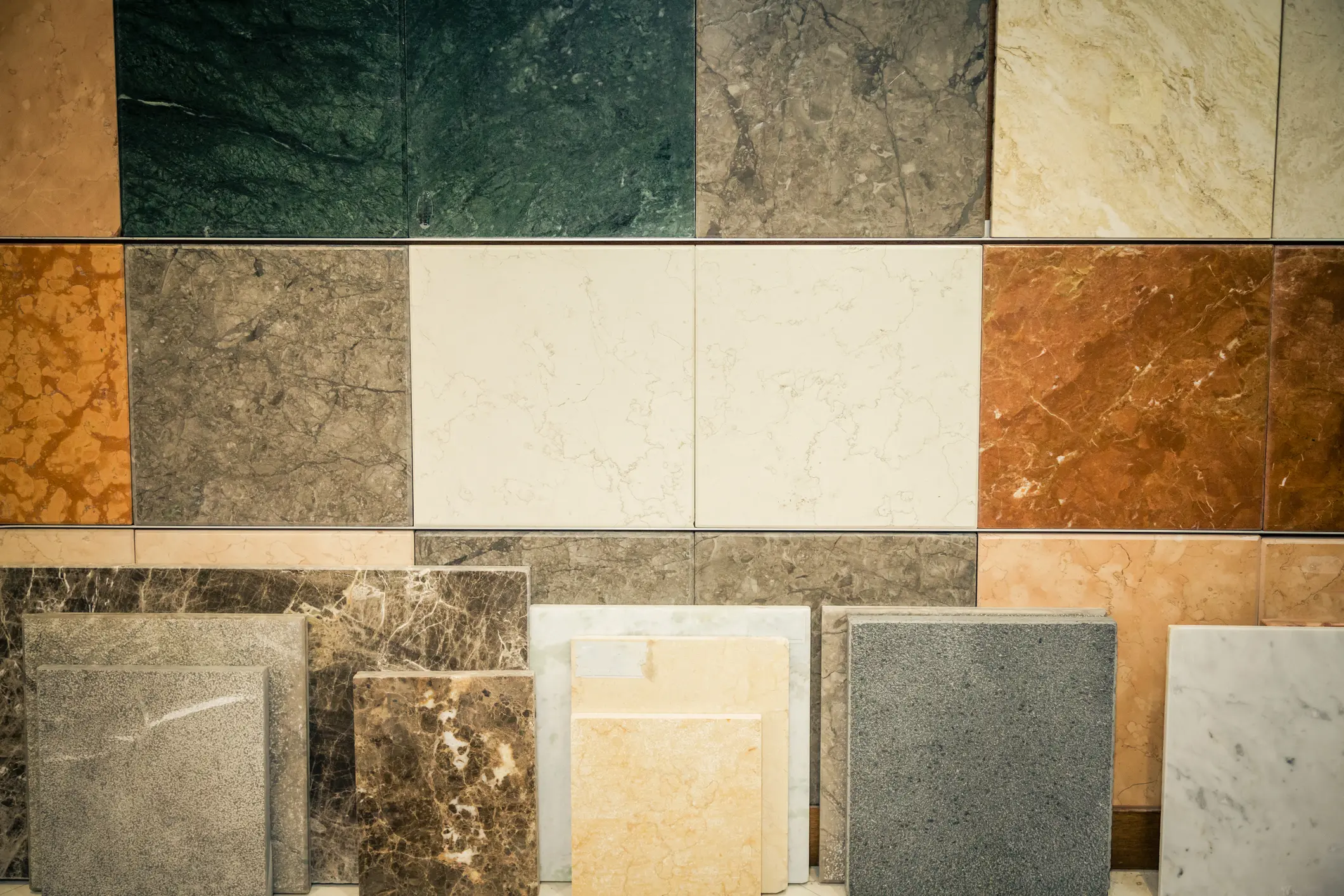A variety of marble and stone tiles arranged in a grid.