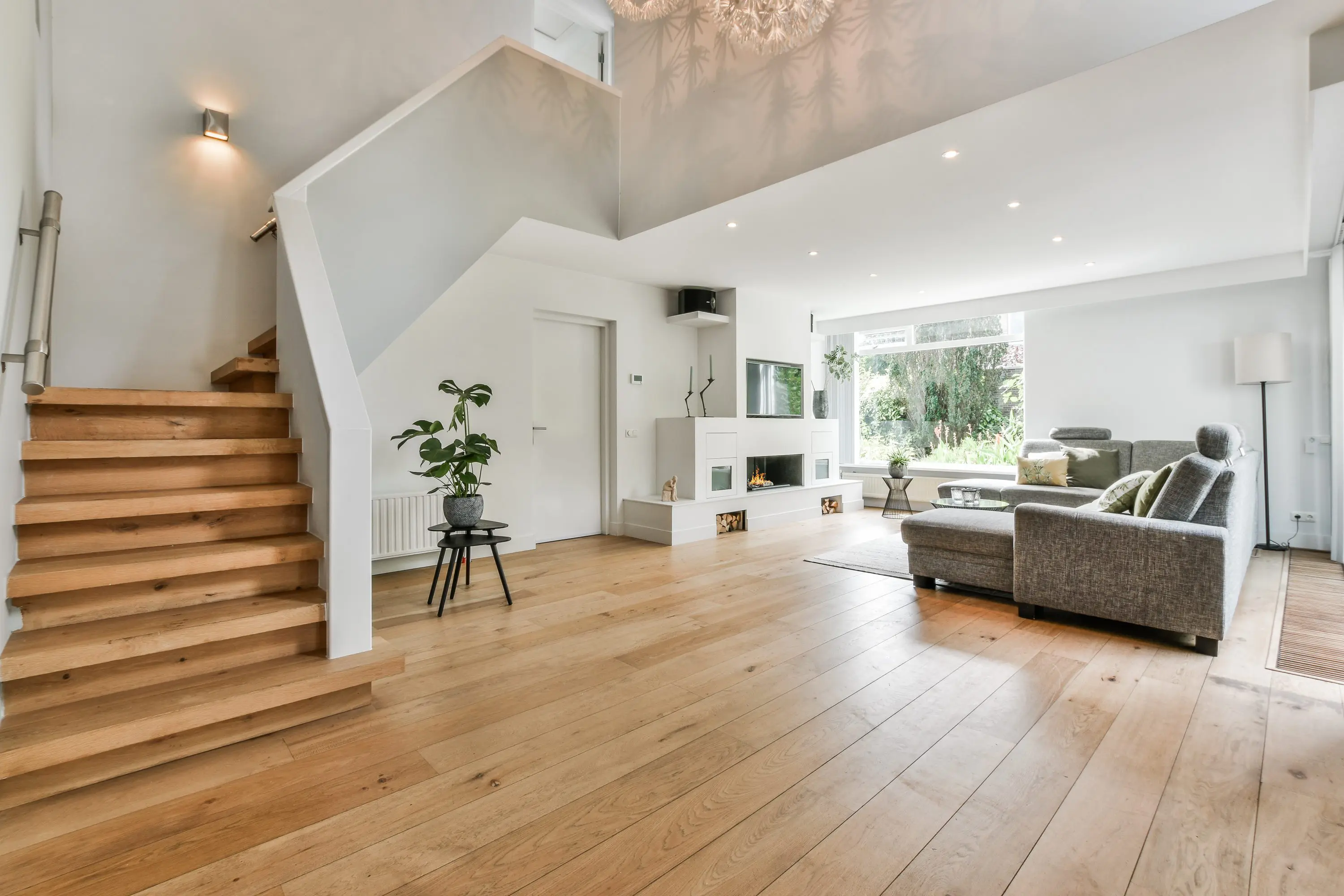 Modern open living space with wooden floors and natural light.